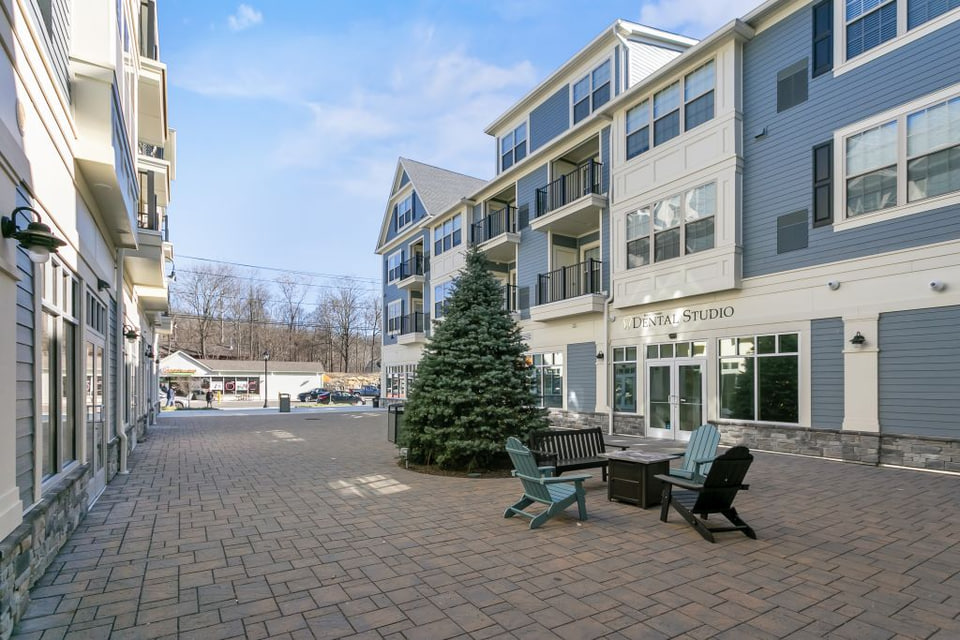 Mixed-use commercial courtyard with exterior trim and storefronts
