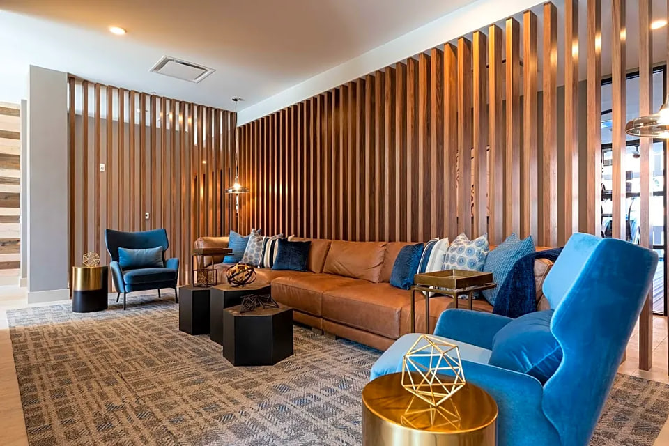 Commercial lounge with a floor-to-ceiling wood-slat partition
