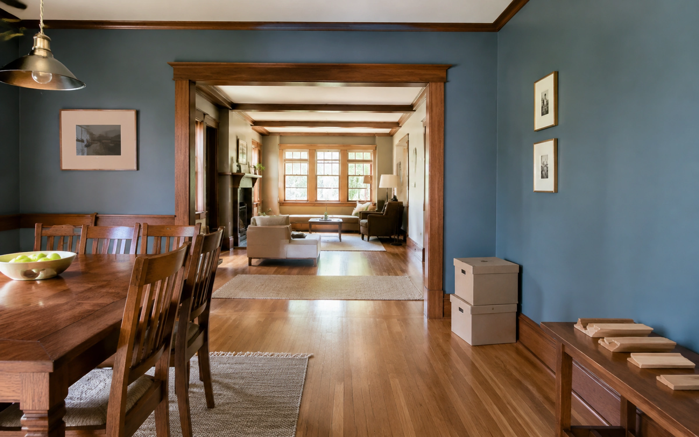 Dining room with furniture, boxed materials and an open route to adjoining rooms.