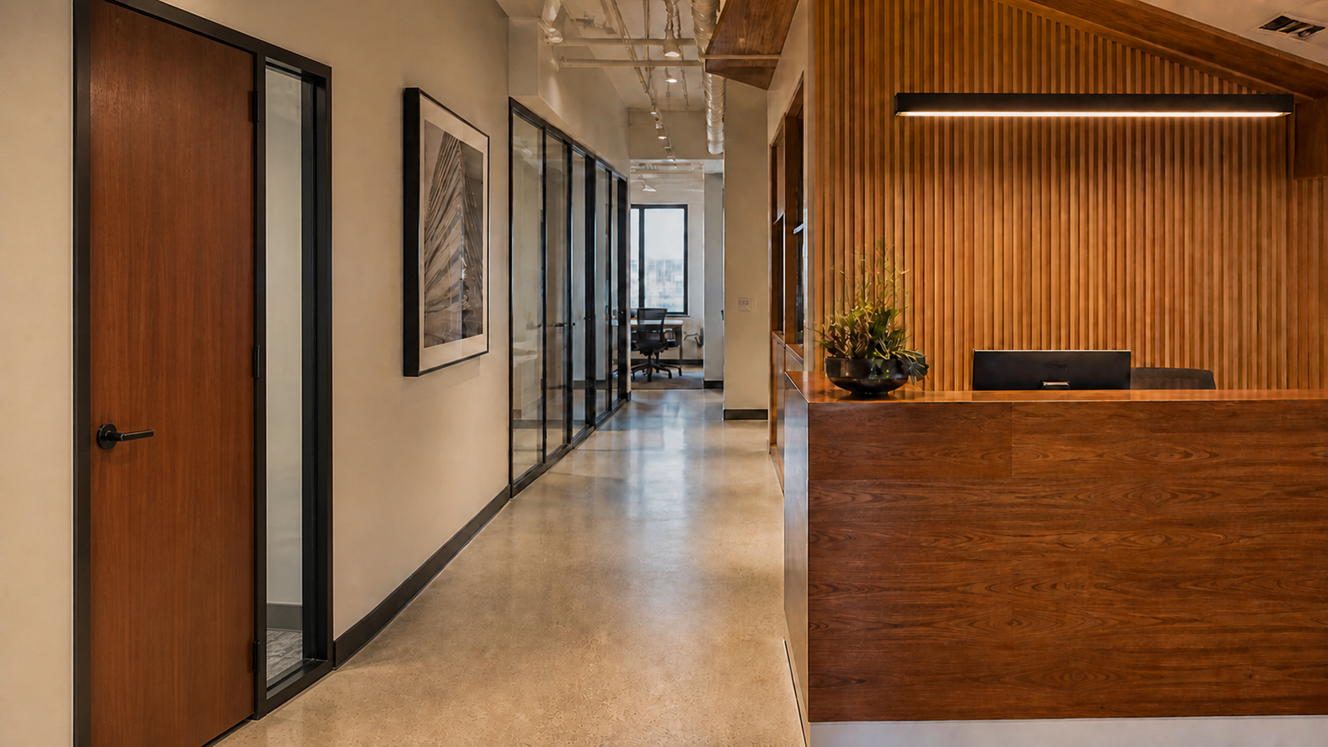 Commercial office reception with wood-slat wall, wood desk, glass-front corridor and wood door