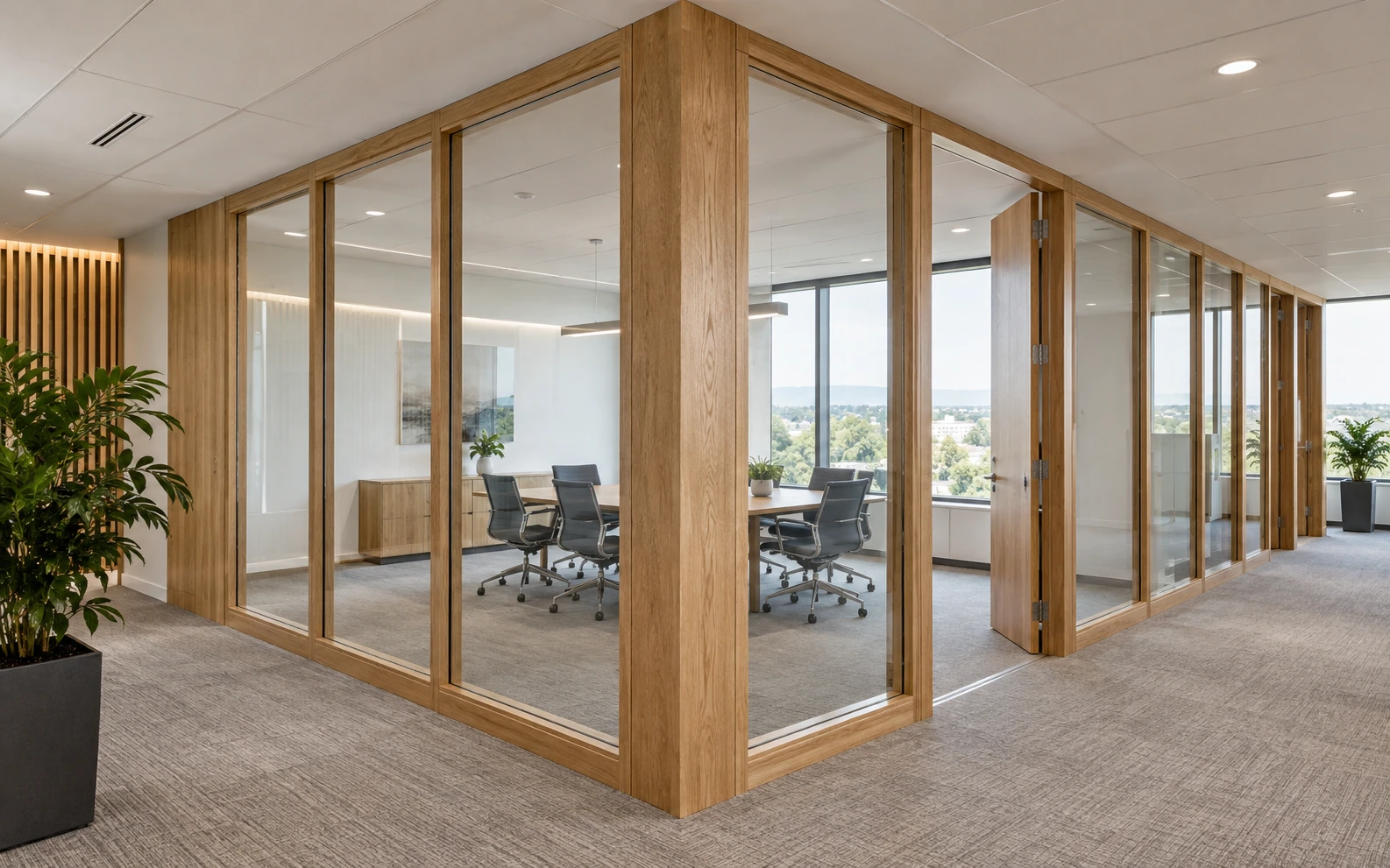 Oak-framed glass partitions around an office meeting room.